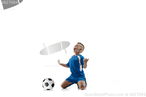 Image of Young boy with soccer ball doing flying kick