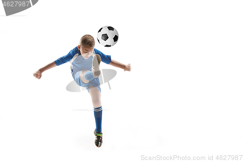 Image of Young boy with soccer ball doing flying kick