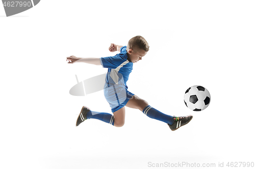 Image of Young boy with soccer ball doing flying kick