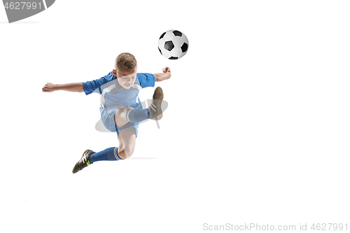 Image of Young boy with soccer ball doing flying kick