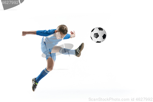 Image of Young boy with soccer ball doing flying kick