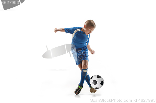 Image of Young boy with soccer ball doing flying kick