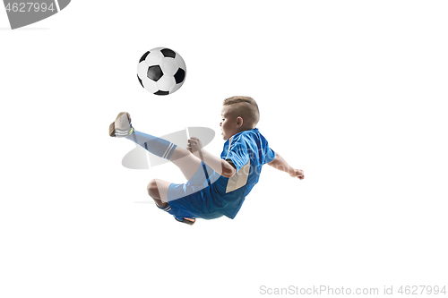 Image of Young boy with soccer ball doing flying kick