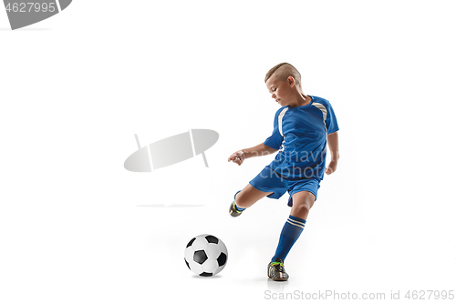 Image of Young boy with soccer ball doing flying kick