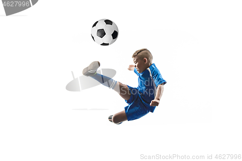 Image of Young boy with soccer ball doing flying kick