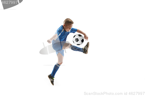 Image of Young boy with soccer ball doing flying kick