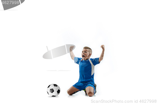 Image of Young boy with soccer ball doing flying kick