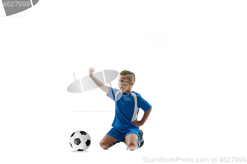 Image of Young boy with soccer ball doing flying kick