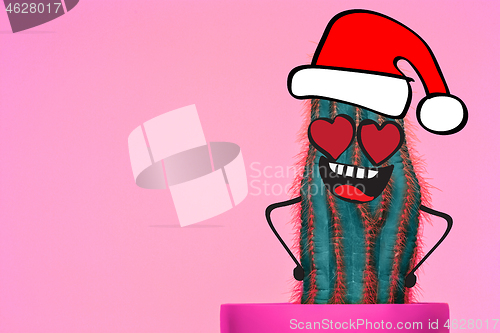 Image of Cactus hipster man with santa hat. Tropical Christmas concept. Minimal fun art