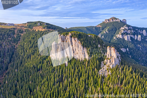 Image of Rocks in sunset colors and evergreen forest