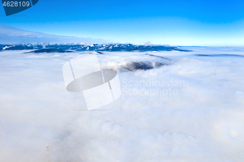 Image of Flying drone over low clouds