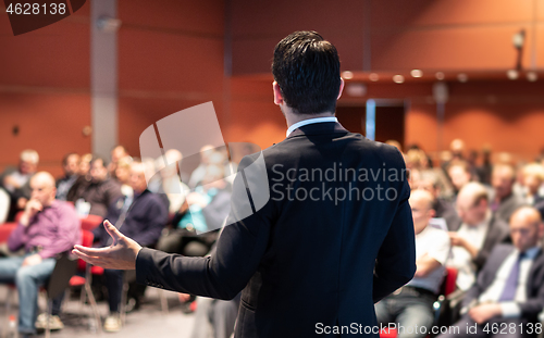 Image of Speaker giving a talk at business conference meeting.