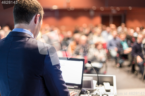 Image of Speaker giving a talk at business conference meeting.