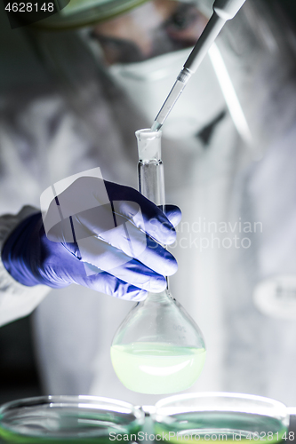 Image of Scientist working in the corona virus vaccine development laboratory research with a highest degree of protection gear.