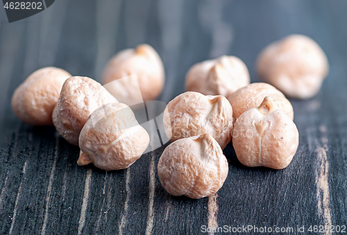 Image of Several dry chickpeas on wooden desk