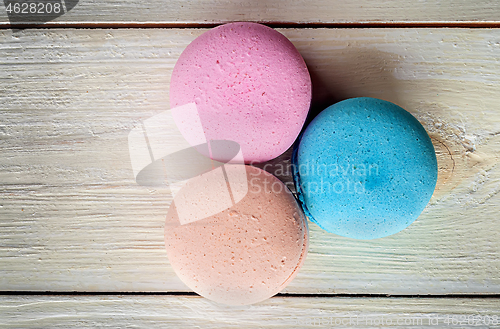 Image of Three macaroons near in white desk