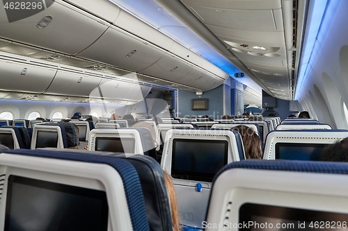 Image of Plane cabin interior full of passengers