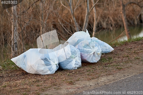 Image of Bags of rubbish in a riverside