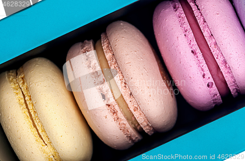 Image of Three macaroons in box closeup