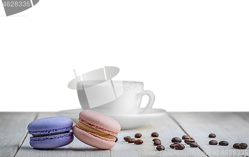 Image of Two macaroons with cup and coffee grains