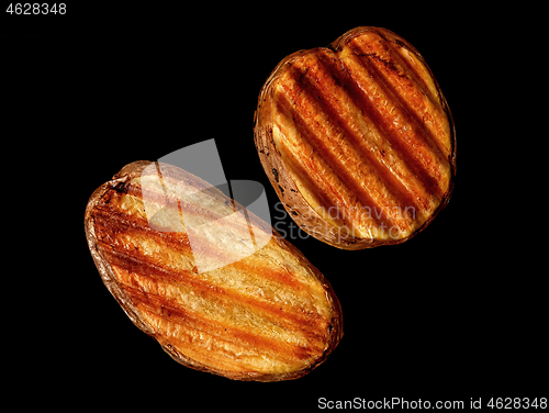 Image of Two slices of grilled potatoes rotated