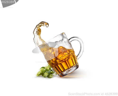 Image of Glass of beer on wooden table with sea on background