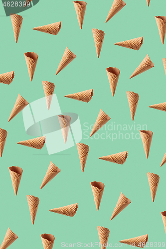 Image of Floating waffle cones pattern for making sweet ice cream dessert.