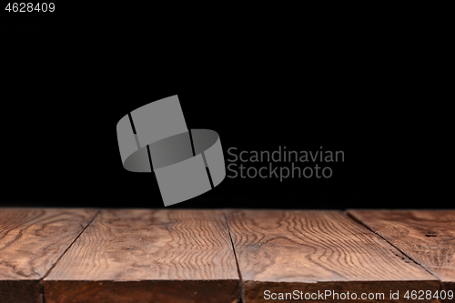 Image of Empty wooden table backdrop on a black background.