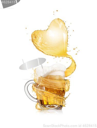 Image of Heart splash of light beer above full glass mug of fresh beverage.