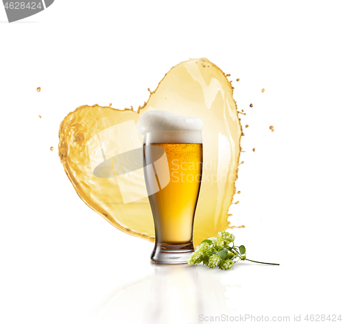 Image of Glass of fresh beer with splash in the shape of heart and hop banch.