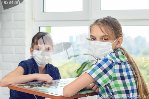 Image of Sick quarantined children play a board games