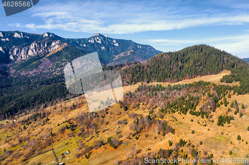 Image of Autumn pasture and rocky mountain behind