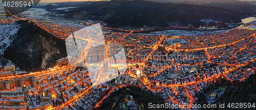 Image of Aerial view of city lights in winter evening.