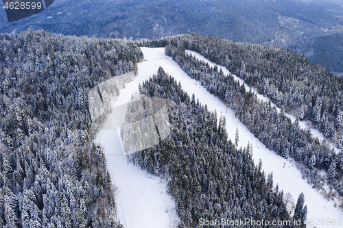 Image of Ski slopes during winter, aerial view