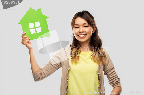 Image of happy asian woman with green house