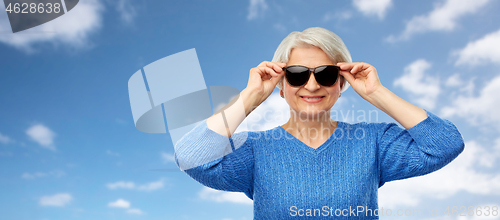 Image of smiling senior woman in black sunglasses