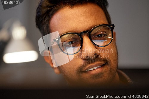 Image of close up of creative man working at night office