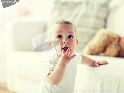 Image of happy little baby boy or girl at home