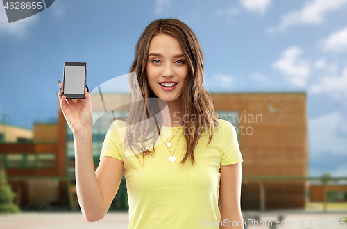 Image of teenage girl holding smartphone over school