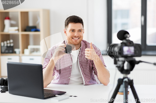 Image of male blogger with smart speaker videoblogging