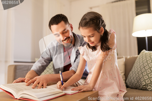 Image of father and daughter doing homework together