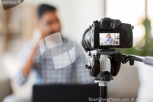 Image of camera recording video blog of indian male blogger