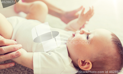 Image of close up of happy little baby and mother hands