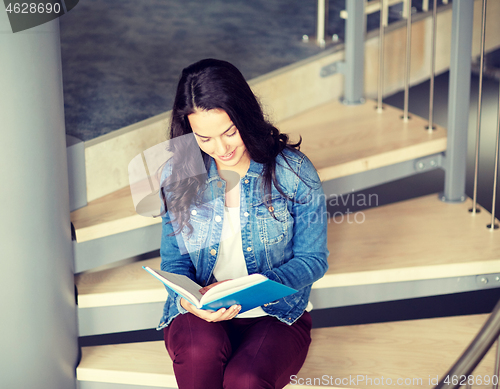 Image of high school student girl reading book on stairs