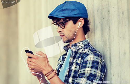 Image of man with earphones and smartphone listening music