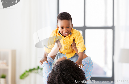 Image of happy african american mother with baby at home