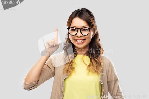 Image of asian woman in glasses or student with finger up