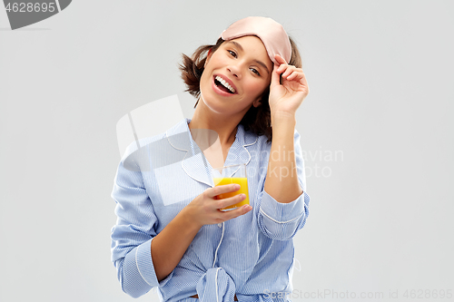 Image of woman in pajama and sleeping mask with juice