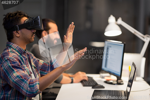 Image of creative man in virtual reality headset at office