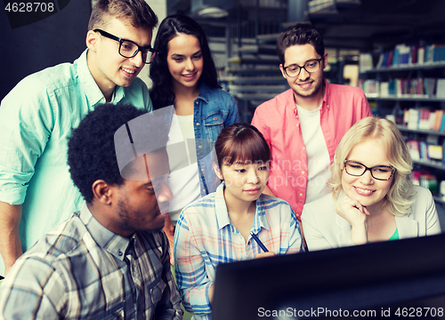 Image of international students with computers at library